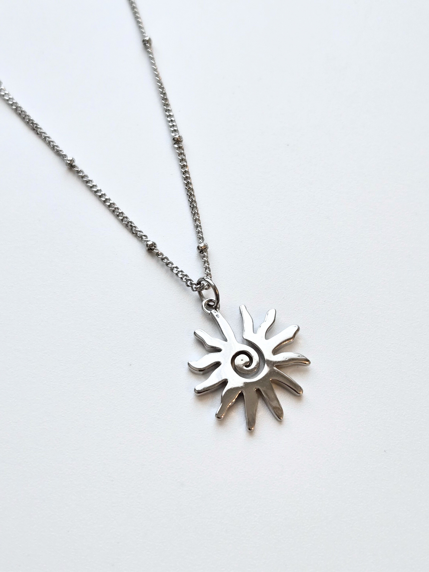 055 | silver swirly sun necklace