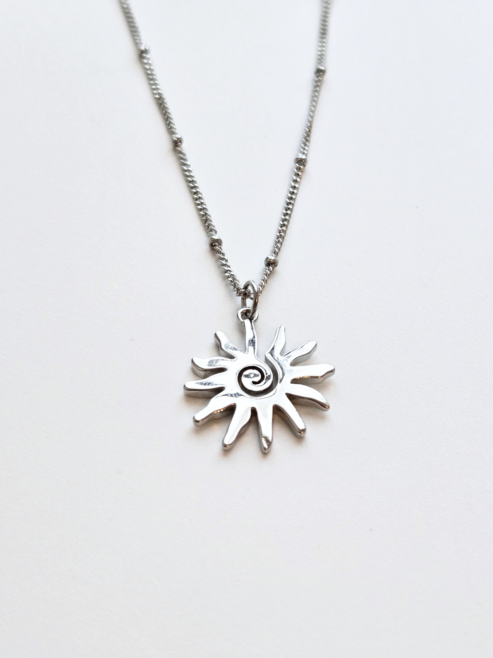 055 | silver swirly sun necklace